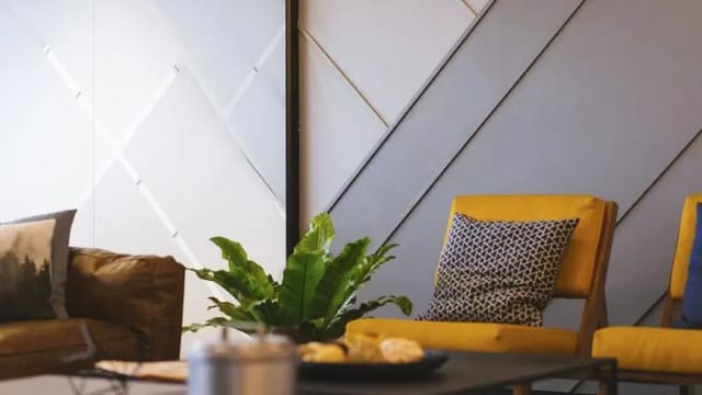 Corner with a green plant, cushion and tray on a table