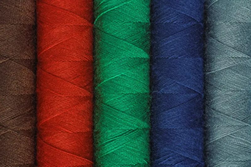 Red, green and blue spools of thread close up