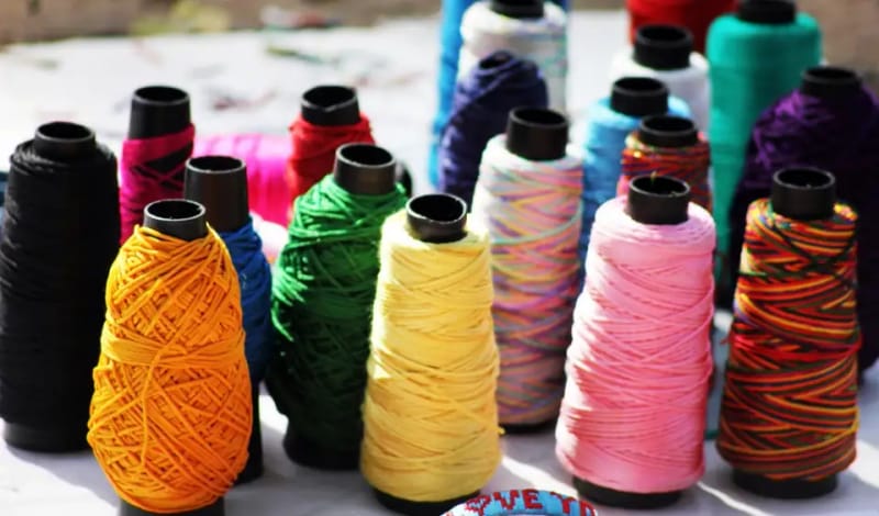 Thread cones in yellow, green, pink and blue