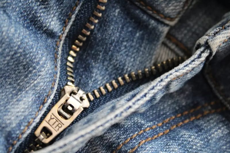 Metal zipper with a slider on jeans