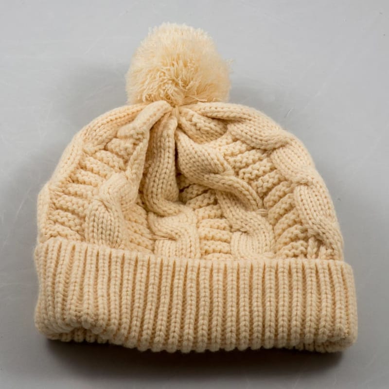 Cream cable-knit hat with pompom