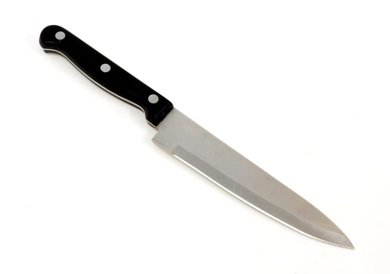 Knife with black handle on white
