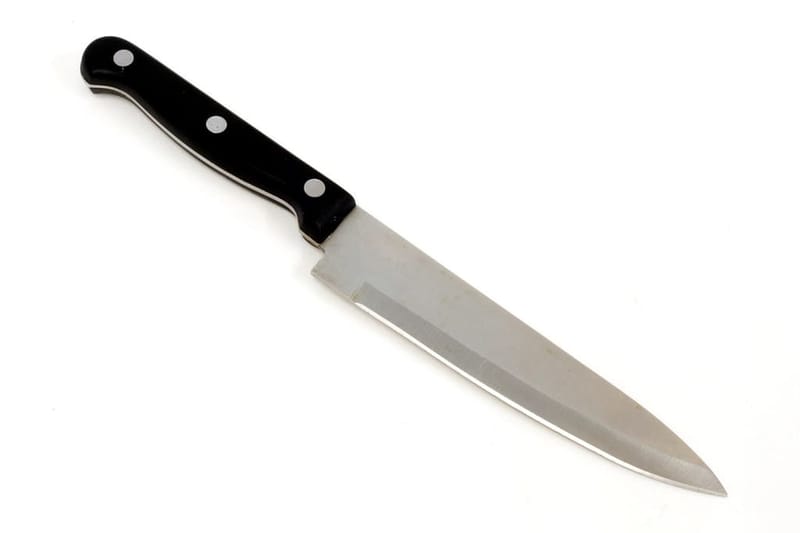 Knife with black handle on white