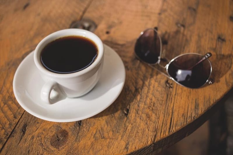 Cup of black coffee on a wooden table