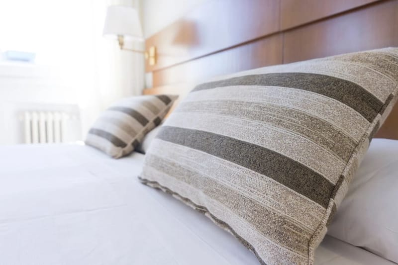 Striped linen cushion on a bed