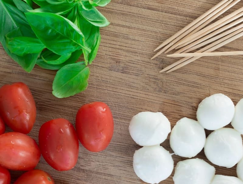 Tomatoes, basil and mozzarella on the board