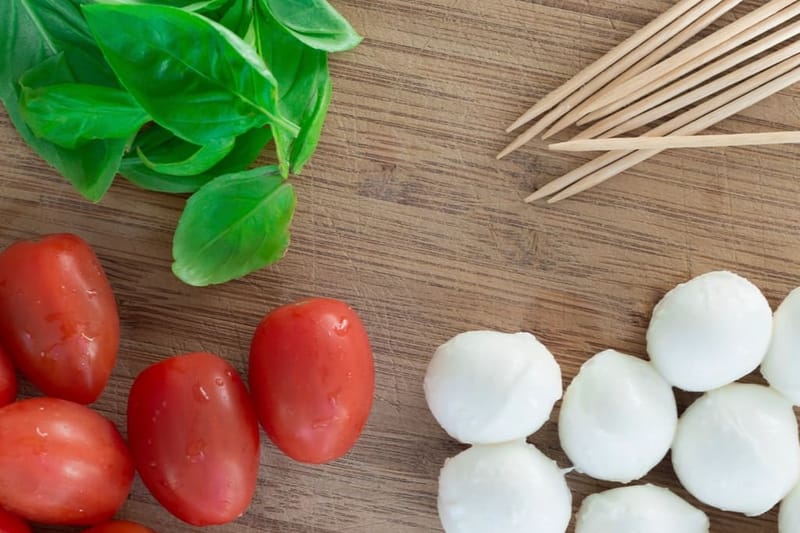 Tomatoes, basil and mozzarella on the board