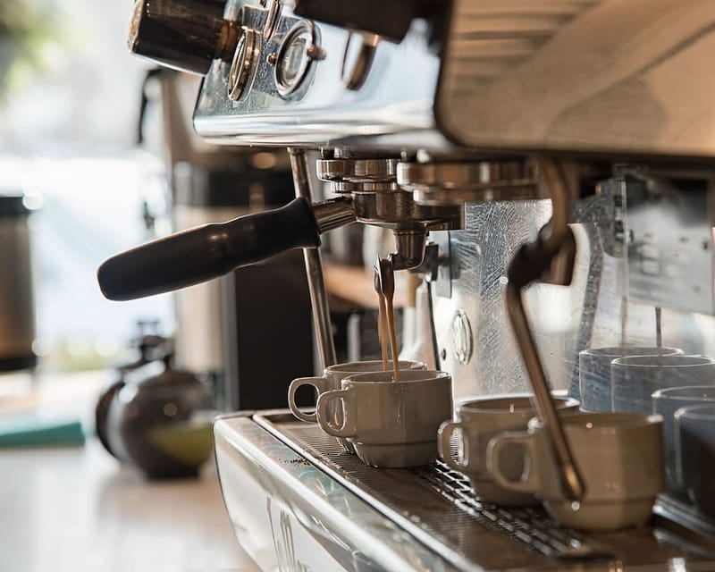 Espresso machine with two cups in a café