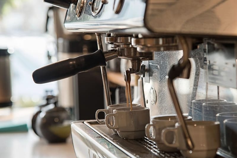Espresso machine with two cups in a café