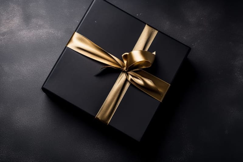 Black gift box with gold ribbon
