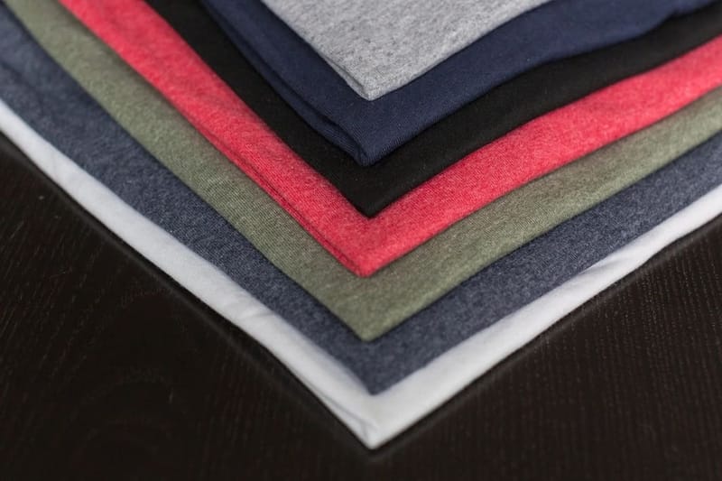 Stack of heavyweight tees in grey, navy, red and olive