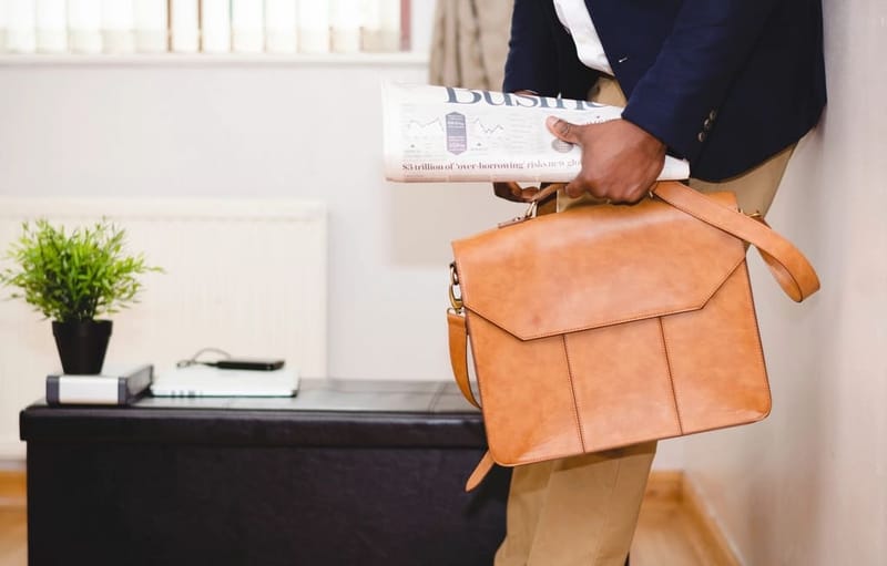 Man carrying a cognac leather bag