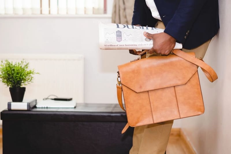 Man carrying a cognac leather bag