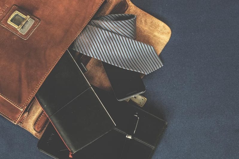Open briefcase with tie and notebook