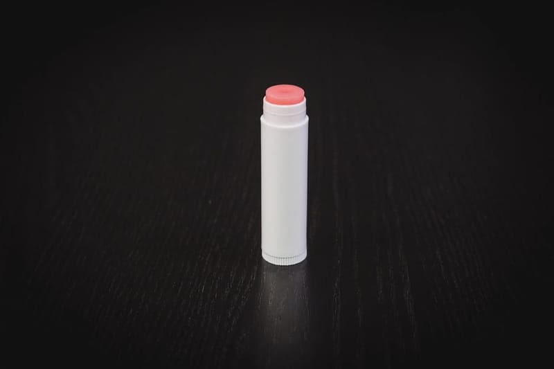 Lip balm stick on dark wood
