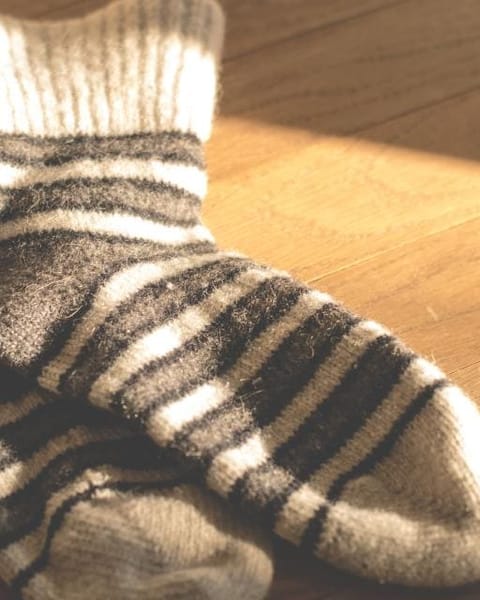 Striped wool socks on a wooden floor