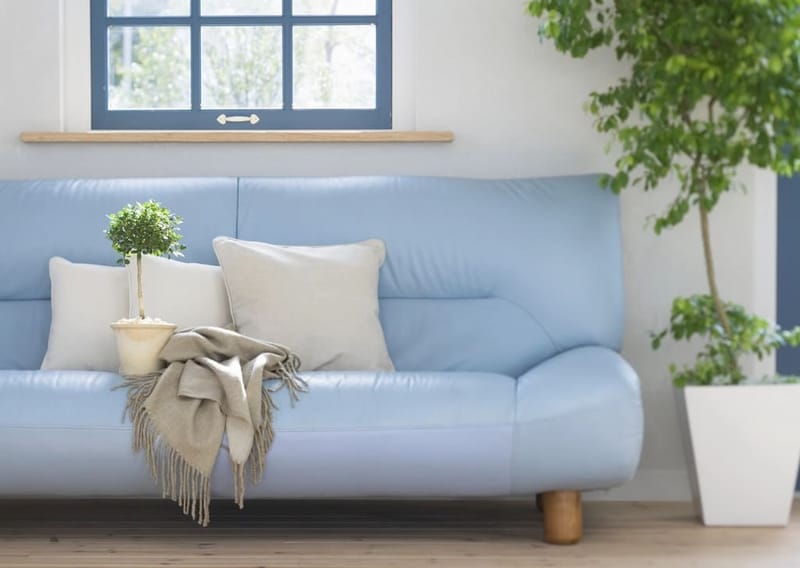 Pale blue sofa with natural cushions