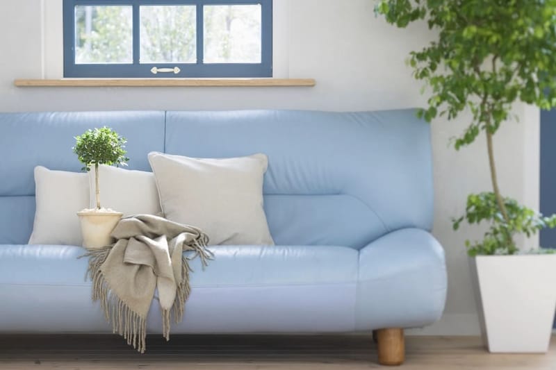 Pale blue sofa with natural cushions