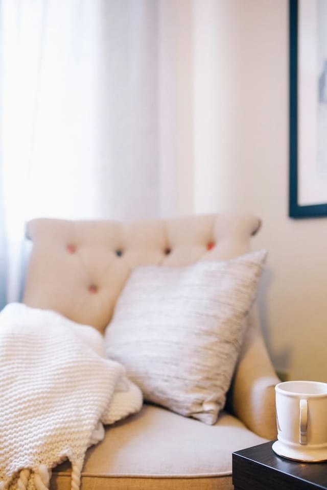 Armchair with a wool throw and cushion