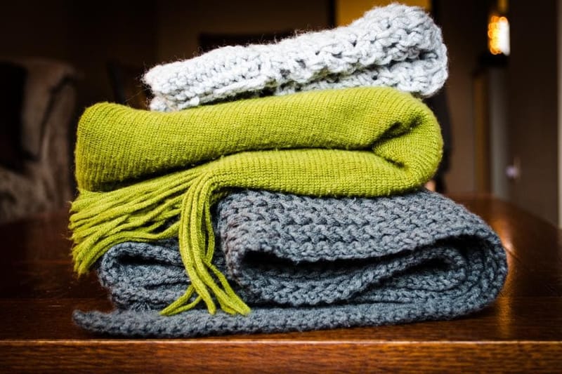 Stacked wool throws in green and grey