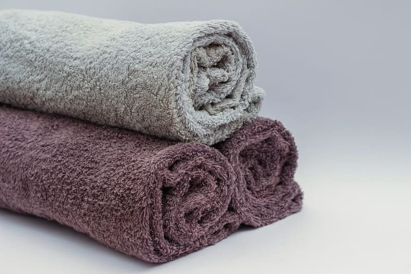 Rolled towels in grey and mauve