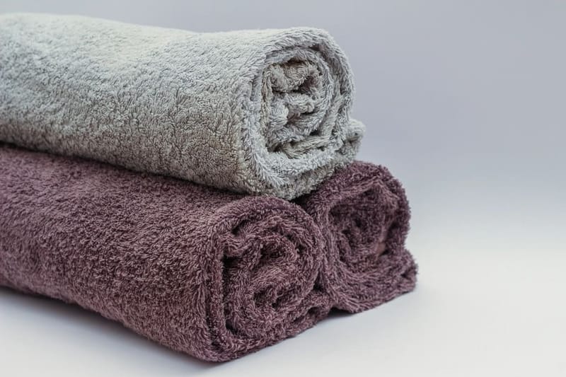 Rolled towels in grey and mauve