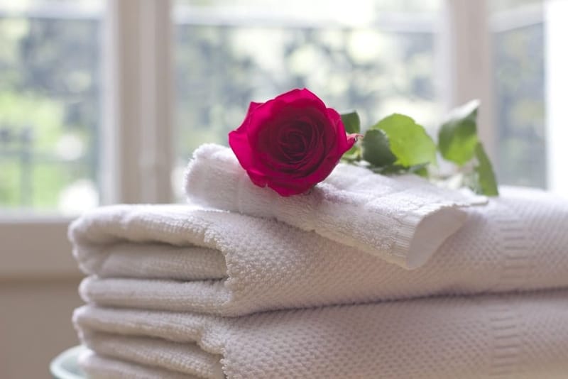White towels with a red rose